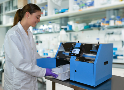 A woman removes the bottom tray from an automated processor for Western Blots