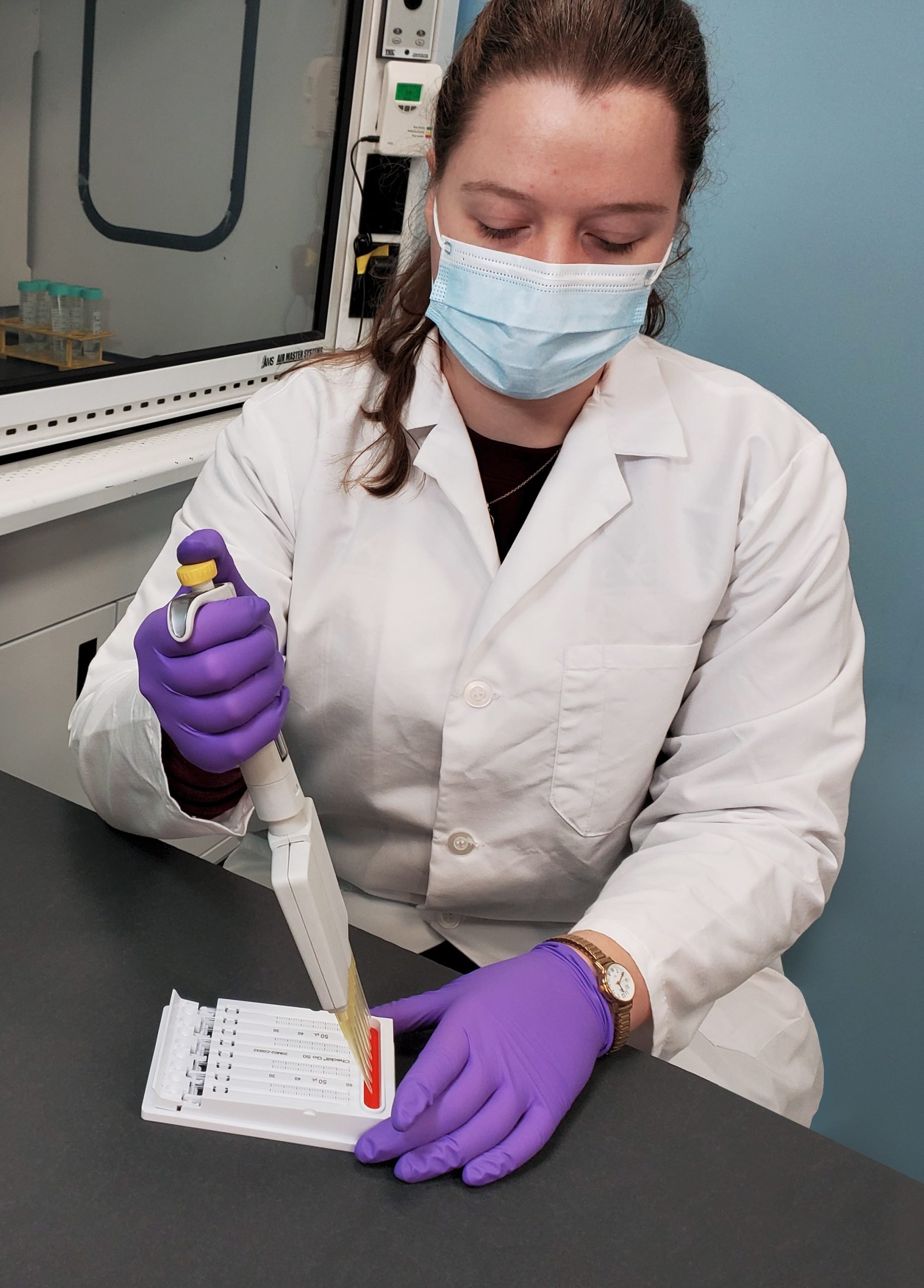 A scientist using the Checkit Go with a multi-channel pipette, demonstrating its ease of use.