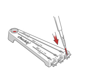 The pipette dispenses red liquid in a Checkit well